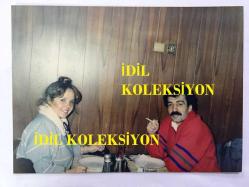 Efemera - MÜSLÜM GÜRSES'İN ORİJİNAL FOTOĞRAFI - 17 x 12,5 cm EBADINDA - MÜSLÜM GÜRSES ve MUHTEREM NUR YEMEK MASASINDAYKEN ÇEKİLMİŞ BİR FOTOĞRAF, MÜSLÜM GÜRSES KIRMIZI KAZAĞIYLA - kitantik - kitaLog