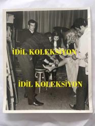 YEŞİLÇAM'IN YILDIZI FATMA GİRİK'İN YEĞENİ MEZİYET NAKKAŞ'LA BİRLİKTE ORİJİNAL BÜYÜK BOY 3'LÜ FOTOĞRAF SETİ - FATMA GİRİK ÇEKİM ÖNCESİ YEĞENİ MEZİYET NAKKAŞ'IN PERUĞUNU TAKARKEN, 3 ADET FOTOĞRAF  - 24 x 18 cm EBADINDA - 1970'LER