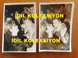 EMEL SAYIN'IN ORİJİNAL 2'Lİ FOTOĞRAF SETİ, 18 x 12 cm EBADINDA - SİYAH & BEYAZ - EMEL SAYIN'IN 1980'LERDEKİ BİR KONSERDE DİNLEYİCİLERDEN BİR BEBEĞİ ALIP KUCAKLADIĞI GÜZEL ANLARDAN 2 FARKLI KARE