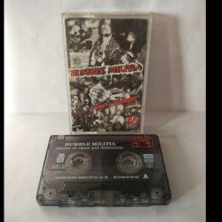 Kaset rumble militia, decade of chaos and destruction albümü. 1997 İzzet Öz Productions. Rumble Militia, 1985'te bir Yunan bir Türk ve iki Alman tarafından Almanya'nın Bremen kentinde kurulmuş thrash metal/crossover grubudur