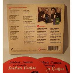 Cd Şükrü Tunar eserleriyle Serkan Çağrı, 2cd  Orijinal. Sorunsuz çalışıyor.  CD: 1  1. Ata Demirer - Adanın Yeşil Çamları    2. Ziynet Sali - Canımın Yoldaşı Ol    3. Gökhan Tepe - Söyleyemem Derdimi    4. Hayko Cepkin - Aşkın İçimde Yara    5. Sıla - Seni Görmeseydim    6. Barbaros* - Gel Sevgilim    7. Nalan* - Unut Beni    8. Birol Namoğlu (Gripin)* - Hülyaya Bürünmüş    9. Gökhan Tepe & Hazal - Güller Arasında    10. Ercan Saatçi - Geçti Sevdalarla Ömrüm    11. Oya İşboğa - Gurbet Elde Her Akşam    12. Ahmet Özhan - Öyle Çektim Ki Cefa    13. Şükrü Tunar & Ayşe Taş - Bir Zamanlar Maziye Bak   CD: 2  1. Adanın Yeşil Çamları    2. Uşşak Oyun Havası    3. Söyleyemem Derdimi    4. Aşkın İçimde Yara    5. Seni Görmeseydim    6. Gel Sevgilim    7. Hicaz Oyun Havası    8. Hülyaya Bürünmüş    9. Geçti Sevdalarla Ömrüm    10. Gurbet Elde Her Akşam    11. Öyle Çektim Ki Cefa    12. Bir Zamanlar Maziye Bak