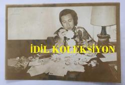 KLASİK TÜRK MÜZİĞİ SANATÇISI ve BESTECİ TANER ŞENER'İN ORİJİNAL AJANS-BASIN FOTOĞRAFI (KAĞIT BASKI) - 18 x 12 cm EBADINDA - TANER ŞENER KENDİSİNE GELEN MEKTUPLARI MASASINDA OKURKEN ÇEKİLMİŞ BİR KARE