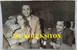 YEŞİLÇAM'DA CİLALI İBO ADIYLA BİLİNEN FERİDUN KARAKAYA'NIN ORİJİNAL FOTOĞRAFI - 18 x 12 cm EBADINDA - FERİDUN KARAKAYA, SİNEMA OYUNCUSU MERAL KÜÇÜKEROL'LA BİRLİKTE BİR GECE KULÜBÜNDE AYNI KAREDE