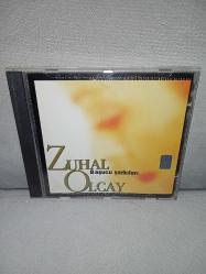 CD Zuhal Olcay başucu şarkıları 1.  Orijinal 2001 Ada Müzik. Disk 10 üzerinden 9.5 Sorunsuz çalışıyor. İyi durumda Koleksiyonluk