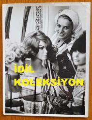 YEŞİLÇAM'IN YILDIZI HÜLYA KOÇYİĞİT'İN ORİJİNAL BÜYÜK BOY 2'Lİ FOTOĞRAF SETİ  - 24 x 18 cm EBADINDA - HÜLYA KOÇYİĞİT BEYAZ BAŞÖRTÜSÜ TAKIP PERUKLARIN YANINDA GÜLÜMSEYEREK KADRAJA POZ VERİRKEN ÇEKİLMİŞ 2 FARKLI KARE