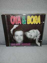 CD Oya Bora seni Bana yazmışlar albümü. Orijinal 1993 kırmızı bandrollü dönem baskı. Dinlemeyi etkilemeyen yoğun çizikler var baştan sona dinlendi sorunsuz çalışıyor