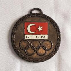 G.S.G.M. - OLİMPİYAT AMBLEMLİ BRONZ RENKLİ MİNELİ MADALYA