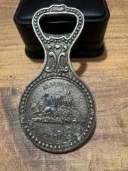 Vintage Gümüş Kaplama Madrid Temalı Şişe Açacağı – Koleksiyonluk  Gümüş kaplama, ağır ve tok bir yapıya sahiptir. Çift taraflı Madrid temalı kabartma işçilik. Bir yüzde: Ünlü Kibele Çeşmesi (Cibeles). Diğer yüzde: Alcalá Kapısı (Puerta de Alcalá) ve Madrid şehir arması.