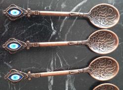 NAZAR BONCUKLU KABARTMA DESENLİ BAKIR RENKLİ 6'LI ÇAY KAŞIĞI.  YENİ