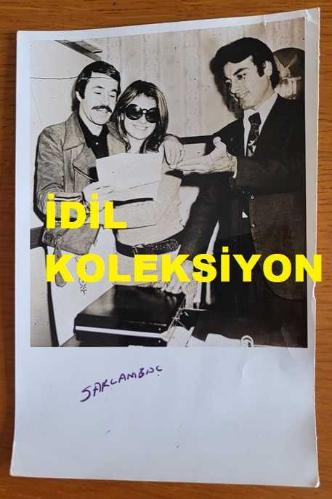 OYUNCU ve SES SANATÇISI SERPİL ÖRÜMCER'İN ORİJİNAL AJANS-BASIN FOTOĞRAFI - 18 x 12 cm EBADINDA - SERPİL ÖRÜMCER, ŞARKICI BERKANT'LA BİRLİKTE MEKTUP OKURKEN ÇEKİLMİŞ BİR KARE
