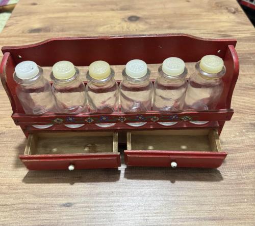 Vintage Ahşap Baharatlık Takımı El boyaması çiçek motifli, kırmızı lake ahşap stand ve   6 adet cam baharat şişesi ve alt kısımda 2 adet fonksiyonel küçük çekmece mevcuttur.